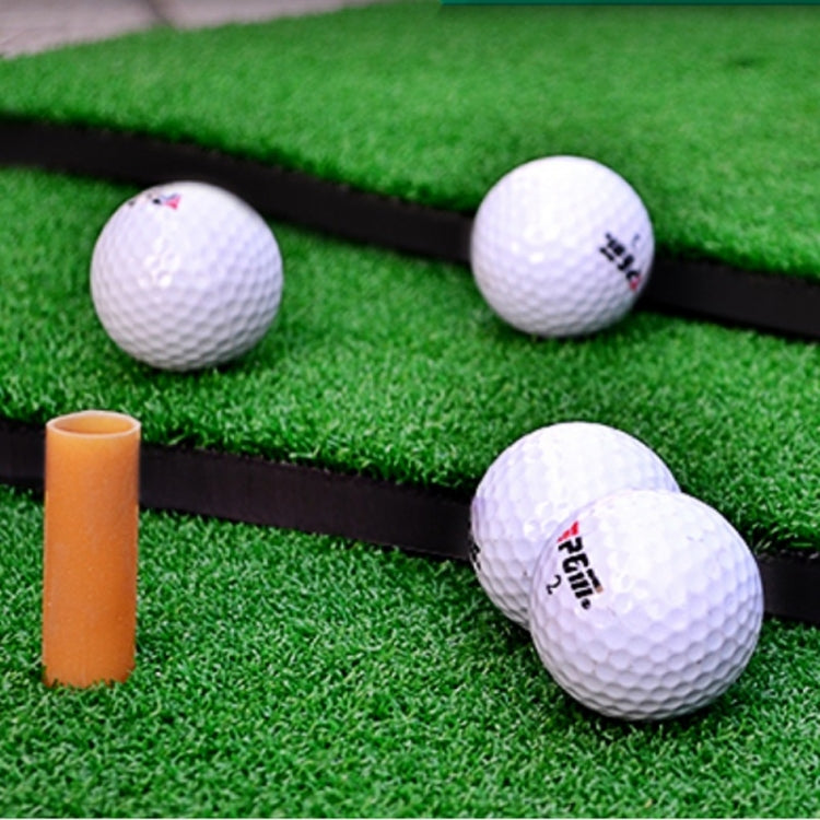 Green turf golf practice mat with white golf balls and orange alignment cone