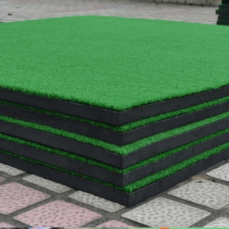 Stacked green turf golf practice mat with black border and black cushioning layers