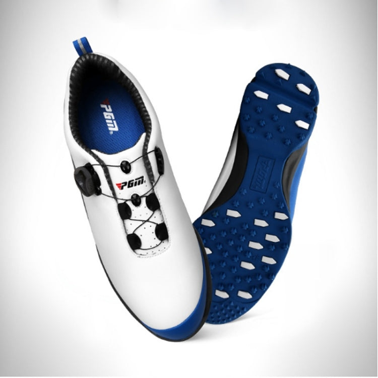 Waterproof golf shoe pair, white uppers with black straps and blue studded outsole