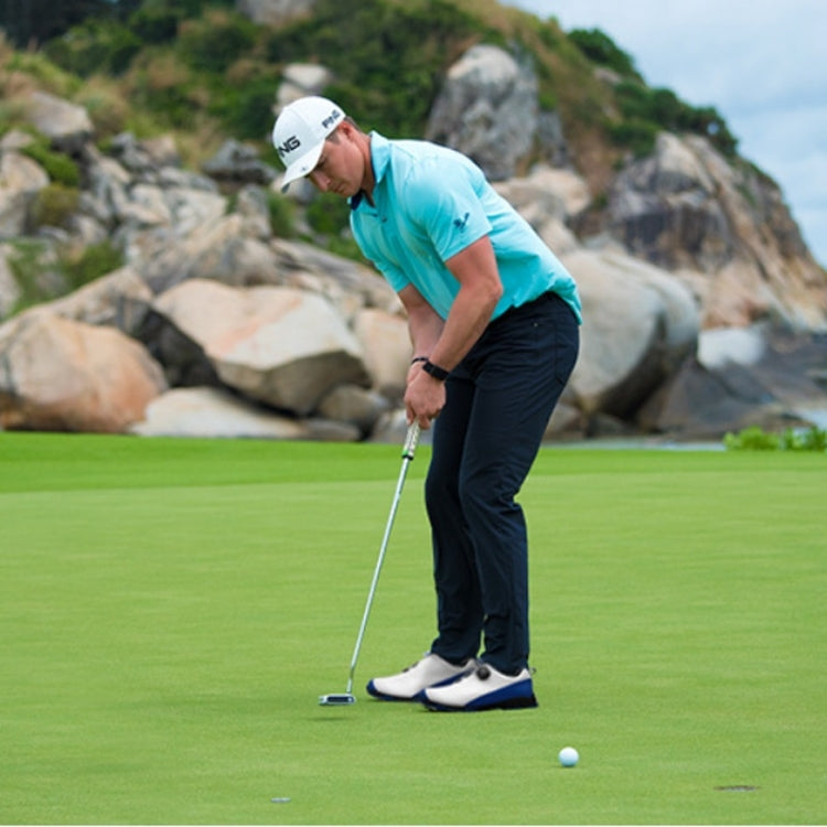 Men's waterproof golf sneakers on a golfer, white shoes with black accents