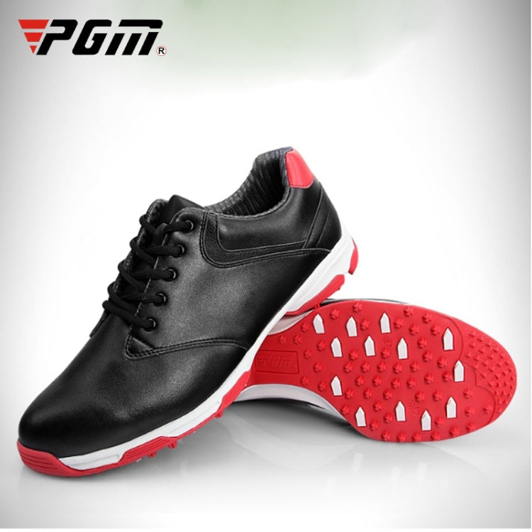 Men's black leather-style golf shoes with red traction outsole and black laces