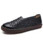 Women's dark embroidered slip-on casual shoes with floral embossing and brown sole.