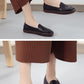 Women's black embroidered slip-on casual shoes, shown from side and front views.