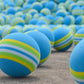 Close-up of blue striped sponge golf practice balls with green and yellow bands