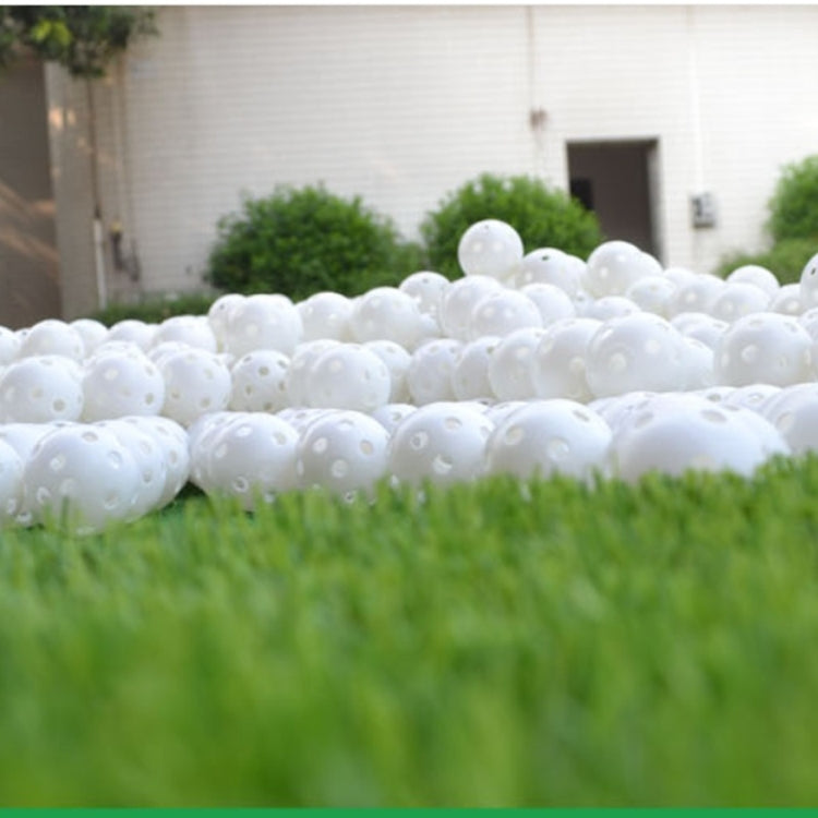 White hollow golf exercise balls, dense group of perforated balls
