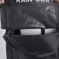 Black golf bag rain cover with zipper seam and fabric flap detail, close-up