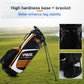 Black golf stand bag with orange accents, white panel, and stable base legs.