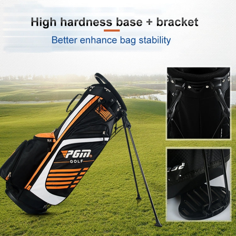 Black golf stand bag with orange accents, white panel, and stable base legs.