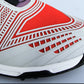 Golf sneaker upper close-up in red with white textured lines and perforations