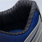 Golf sneaker heel collar close-up with black lining and blue side panel