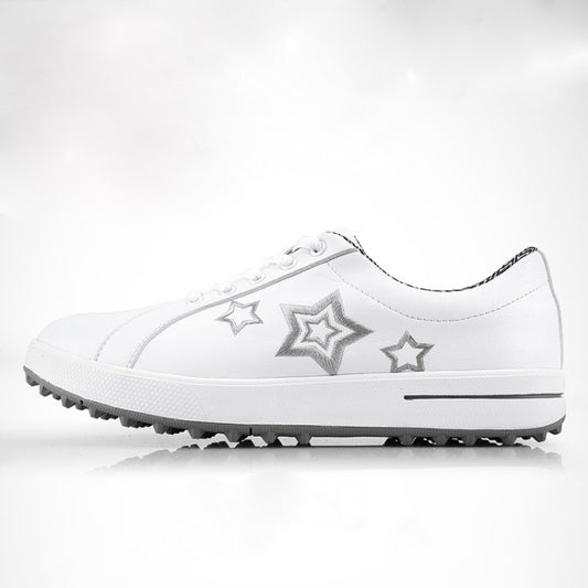 White lace-up women’s golf shoes with silver star patches on the side