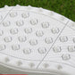 White sneaker outsole with molded traction pattern and raised studs