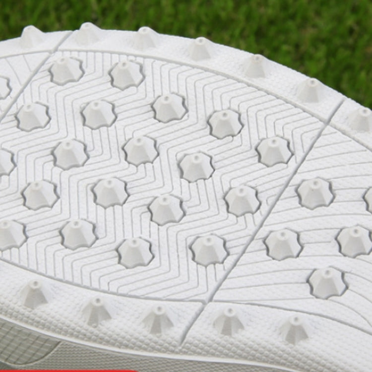 White sneaker outsole with molded traction pattern and raised studs