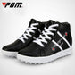 Black high-top golf sneakers front view; white laces, side graphic, and studded sole