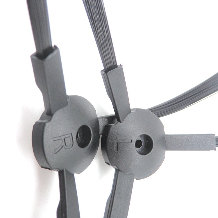 Close-up of robot side brush hubs and black bristle arms