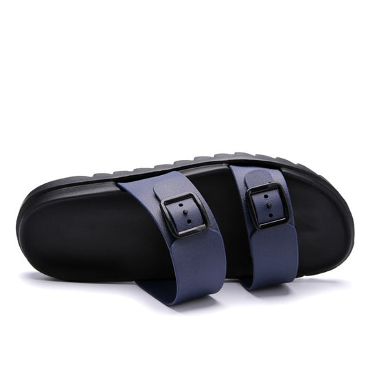 Blue slide sandals side view with two buckled straps and thick black sole