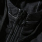Close-up of black denim jacket zipper and hood draw cord with black pull tab