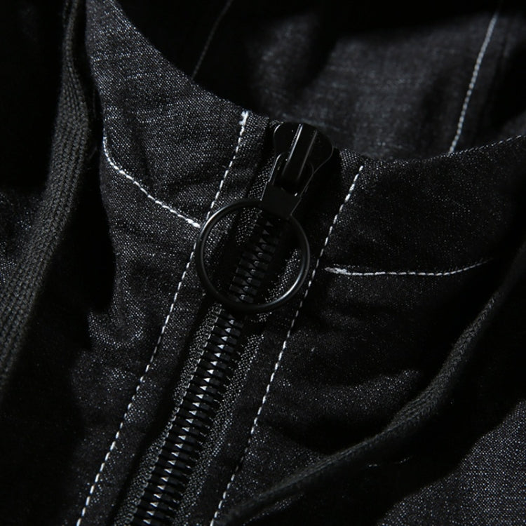Close-up of black denim jacket zipper and hood draw cord with black pull tab