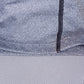 Close-up of heather gray knit with black stitched seam and stretchy fabric