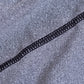 Black stitched piping detail on heather gray stretchy fabric