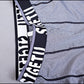 Logo waistband detail on light gray compression tights with contrast stitching