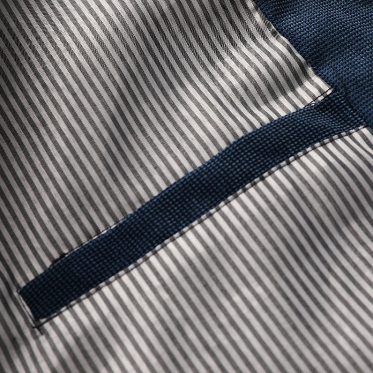 Striped lining with navy edge trim along a seam