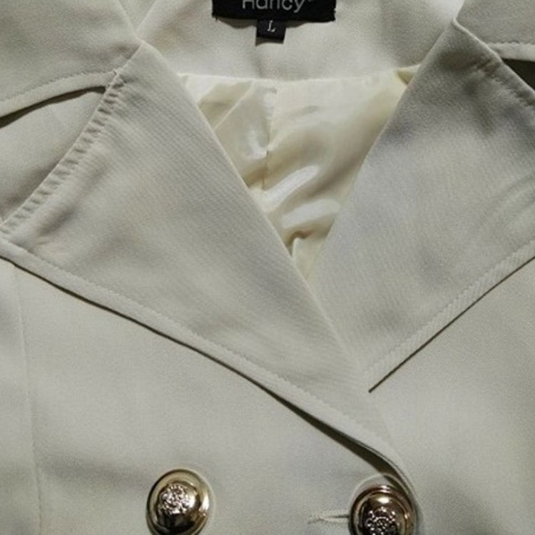 Light beige trench jacket fabric detail with V-neck facing and embroidered trim