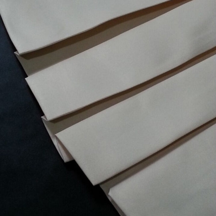 Folded light-colored fabric panels with stitched edges