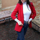 Red open-front blazer with lapels, long sleeves, styled with a waist belt