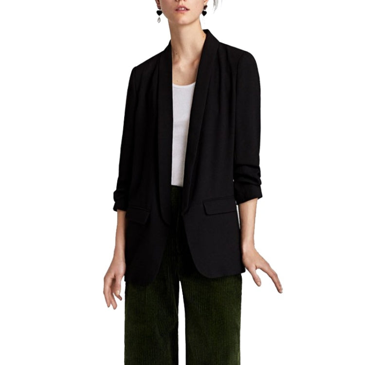 Black blazer with lapels and front pockets, relaxed drape, paired with dark pants