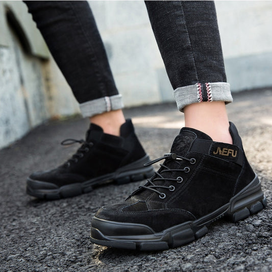 Black lace-up high-top safety shoes on pavement with chunky protective outsole