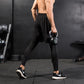 Black athletic shorts over black leggings with elastic waist and slim ankle fit.