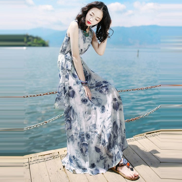 Sleeveless blue abstract print maxi dress with scoop neckline and flowing, tiered skirt