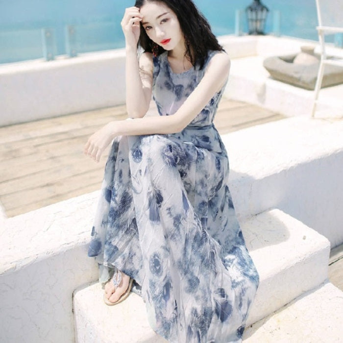 Blue abstract print sleeveless maxi dress with scoop neck and gathered, fluttering hem