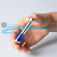 Desktop anti-stress magnet toy held in hand, blue base with silver metal chamber