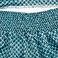 Close-up of teal-and-navy patterned fabric with elastic waistband