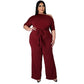 Wine red off-shoulder jumpsuit with draped neckline, tie waist, and wide-leg pants
